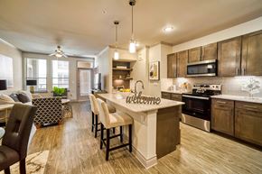 Houston apartment for rent - A modern kitchen with a large island and a welcome sign.