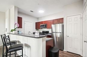 Lawton apartment for rent - a kitchen with a island and a stainless steel refrigerator