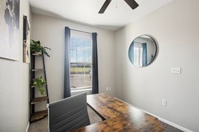 Lawton apartment for rent - a dining room with a large window and a desk with a laptop