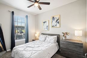 Lawton apartment for rent - a bedroom with a bed and a ceiling fan