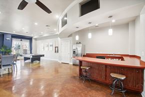 Lawton apartment for rent - a game room with a pool table and a bar with stools