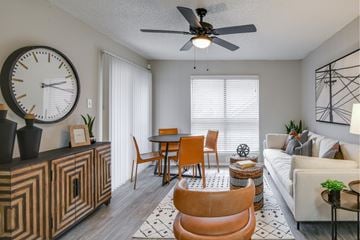 North Richland Hills apartment for rent - A living room with a brown chair and a white couch.