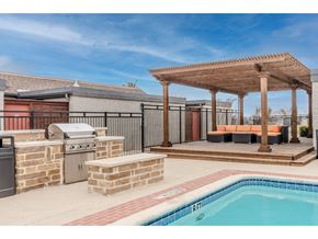 Denton townhouse for rent - a backyard with a pool and a patio with a grill