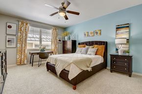 Hurst apartment for rent - a bedroom with a bed and a ceiling fan