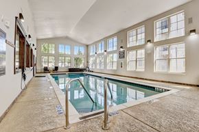 Hurst apartment for rent - the indoor pool is spacious and has windows and a glass railing around it