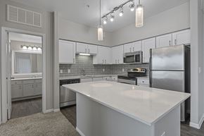 Kyle apartment for rent - A kitchen with a large island in the middle.
