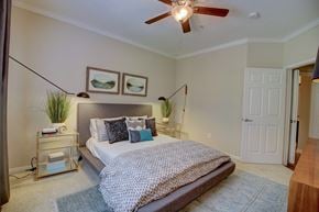 The Woodlands apartment for rent - a bedroom with a bed and a ceiling fan