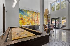 San Antonio apartment for rent - A pool table in a room with a large painting on the wall.