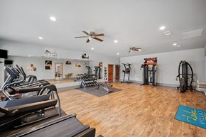 Granbury apartment for rent - the spacious fitness room has a treadmill, elliptical and weights machines