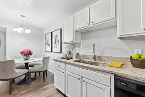 Denton apartment for rent - a kitchen with a sink and a table with chairs