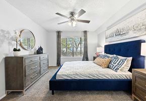 Denton apartment for rent - a bedroom with a bed and a ceiling fan