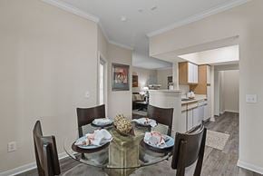 Houston apartment for rent - a dining room with a glass table and chairs and a kitchen