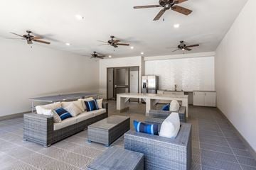 Euless apartment for rent - A modern living room with a grey sofa and a white table.