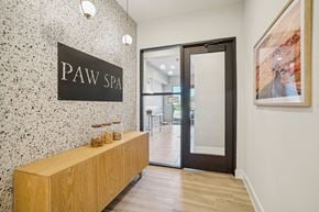 Waxahachie apartment for rent - a lobby with a pay spa sign on the wall and a wooden reception desk