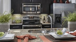 Pearland apartment for rent - a kitchen with granite counter tops and stainless steel appliances