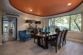 Little Rock apartment for rent - a dining room with a wooden table and blue chairs