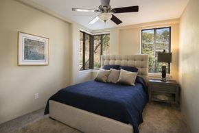 Little Rock apartment for rent - a bedroom with a bed and a ceiling fan