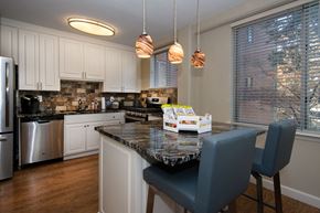 Little Rock apartment for rent - a kitchen with white cabinets and a granite counter top