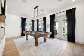 Azle apartment for rent - a game room with a pool table and windows with black curtains