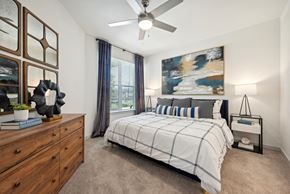 Azle apartment for rent - a bedroom with a bed and a ceiling fan