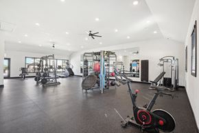 Decatur apartment for rent - a gym with weights and cardio equipment in a building with white walls