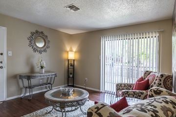 Austin apartment for rent - A living room with a glass table and a sofa.