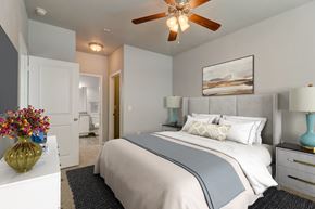 San Antonio apartment for rent - a bedroom with a large bed and a ceiling fan