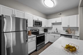 Memphis apartment for rent - a kitchen with white cabinets and stainless steel appliances
