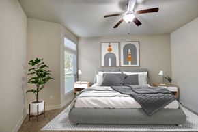 Spring apartment for rent - a bedroom with a bed and a ceiling fan