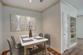 Conroe apartment for rent - a dining room with a table and chairs and a door to a closet