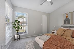 Oklahoma City apartment for rent - a bedroom with a bed and two windows and a ceiling fan