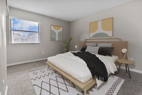 Oklahoma City apartment for rent - a bedroom with a bed and a window and a rug