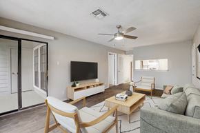 New Braunfels apartment for rent - an open living room with a ceiling fan and a tv