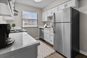 Oklahoma City apartment for rent - an open kitchen with stainless steel appliances and white cabinets
