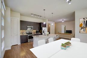 Spring apartment for rent - a kitchen and dining room with a white table
