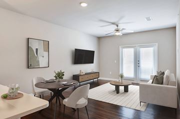 Katy apartment for rent - A modern living room with a dining table and chairs.