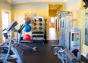 St. Marys apartment for rent - A gym with a variety of equipment including a treadmill, weights, and a fitness ball.