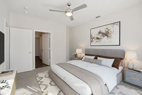 Plano apartment for rent - A large bedroom with a modern ceiling fan.