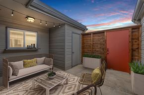 Denton townhouse for rent - a patio with a couch and chairs and a red door