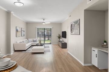Lewisville apartment for rent - A living room with a white couch and a wooden floor.