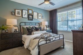 Dallas apartment for rent - a bedroom with a bed and a ceiling fan