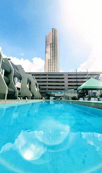 Resort style swimming pool with city skyline