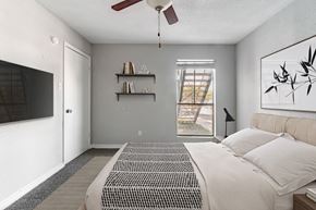 Houston apartment for rent - Modern bedroom with wall mounted television at 2151 Kirkwood Apartments, Houston, Texas
