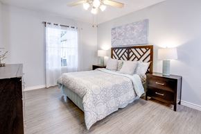 Houston apartment for rent - A bedroom with a large bed and a ceiling fan.