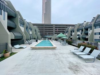 Swimming pool area with lounge chairs and amenities