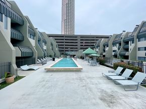 Houston apartment for rent - Cozy balcony with outdoor seating and string lights at Augusta Court Apartments, Houston, TX