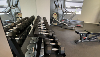 Fitness center with free weights and cardio equipment