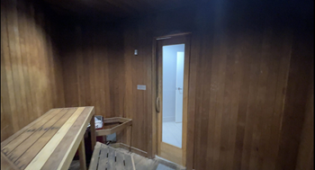 Wooden sauna with glass door