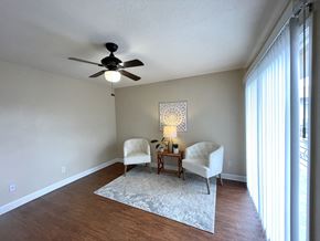 Houston apartment for rent - A room with a ceiling fan and two chairs.