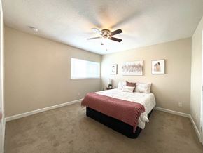 Houston apartment for rent - a bedroom with a bed and a ceiling fan
